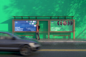 A man walking in by the bus station with LIN banner